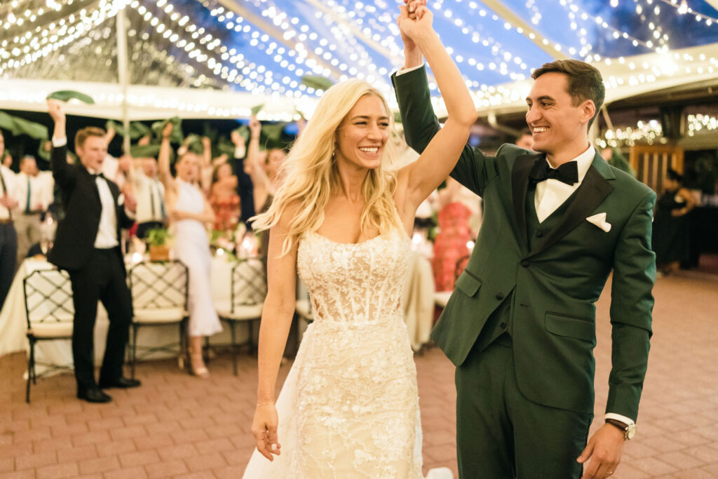 bride and groom dancing under clear top tent with twinkle lighting