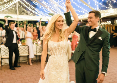 bride and groom dancing under clear top tent with twinkle lighting