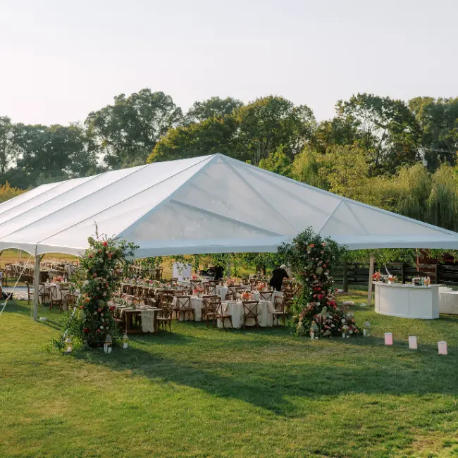 cleartop-wedding-tent-with-florals A cleartop wedding hip end tent by Collective Event Group