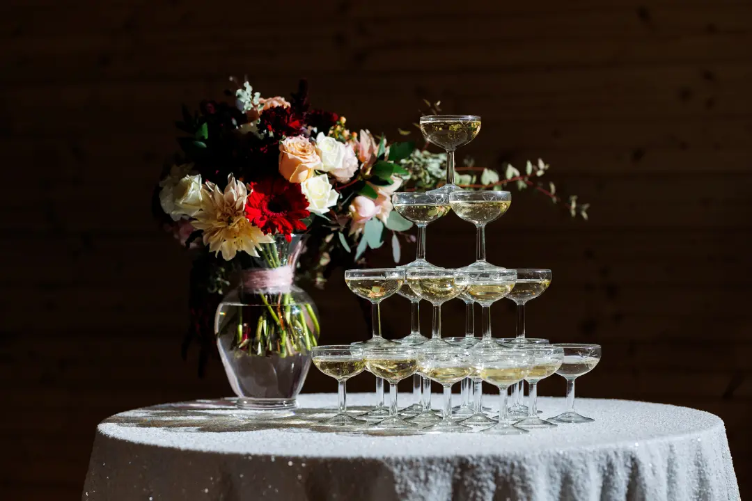 A champagne tower made with coupe champagne rental glasses by Collective Event Group